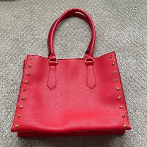 Red studded faux leather bag